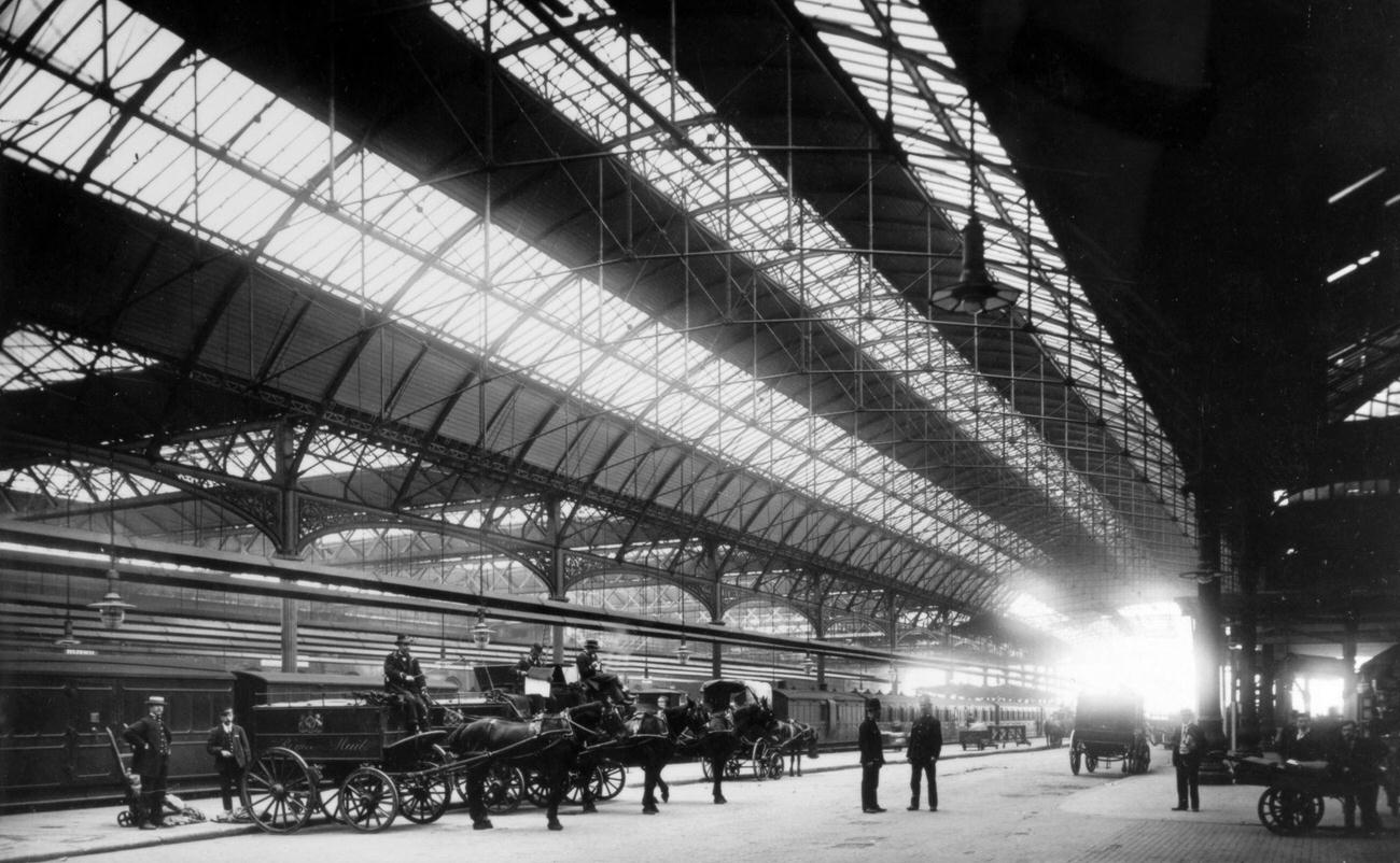 London Bridge Railway Station at the turn of the century with horse drawn mail vans on the platform.