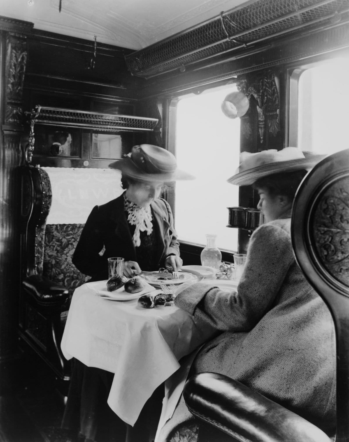 Two female passengers eating a meal in a London & North Western Railway dining car, 1905.