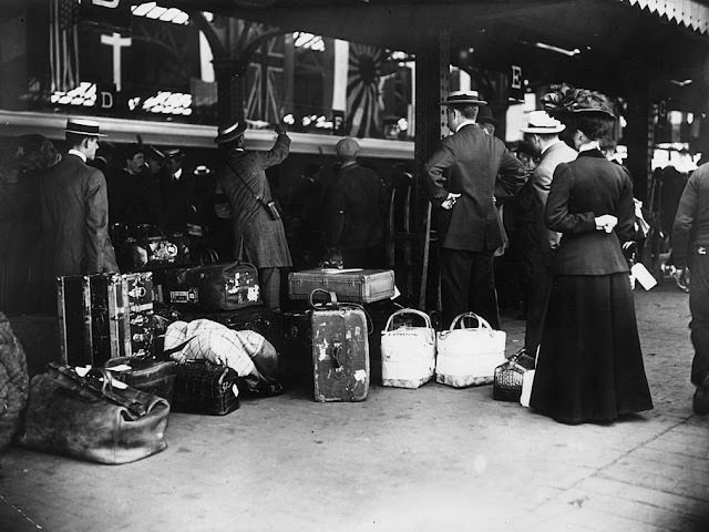 People used to dress up for train travel. Passengers waiting with their luggage to board the first special passenger train to London.