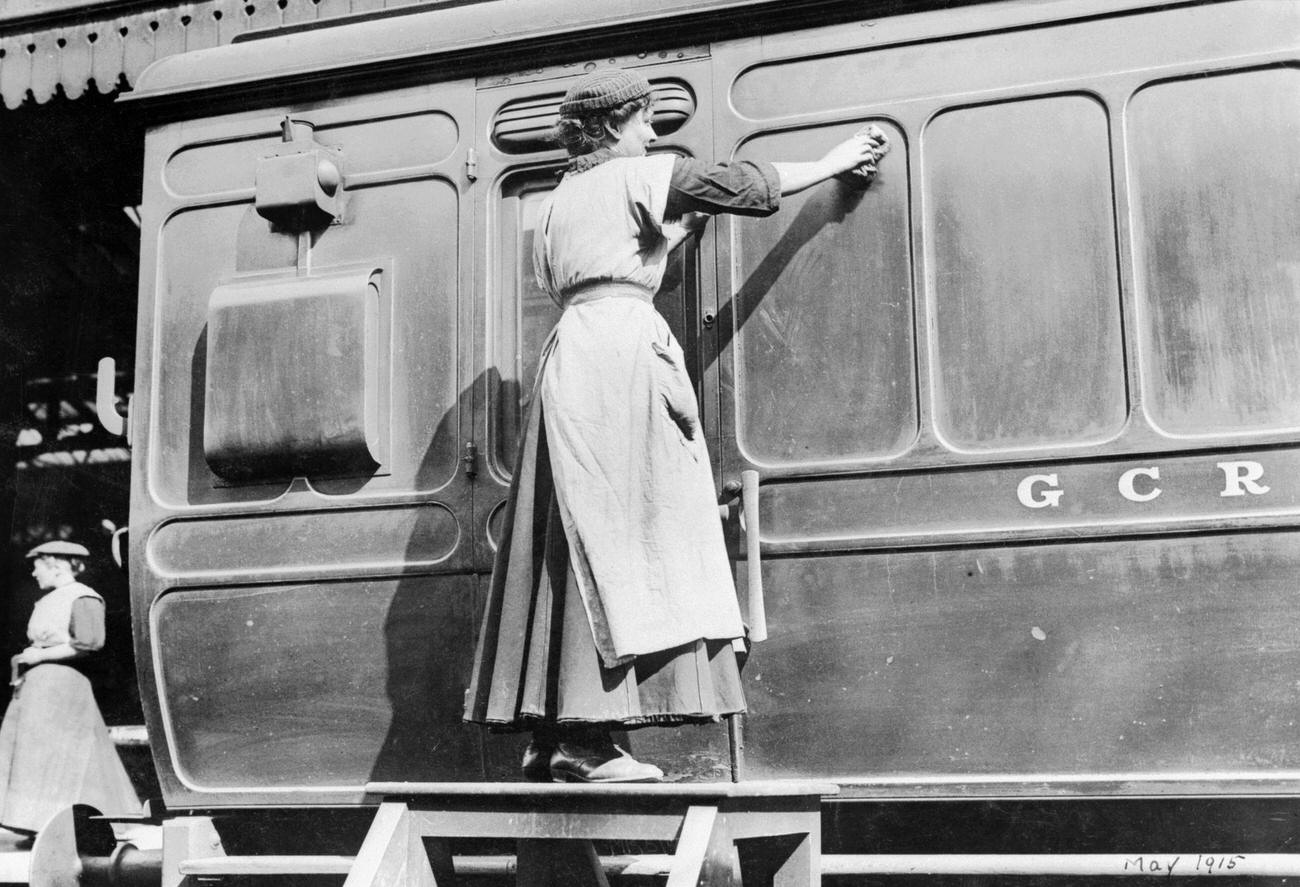 A woman cleaning railway carriages at Marylebone station, April 1915.