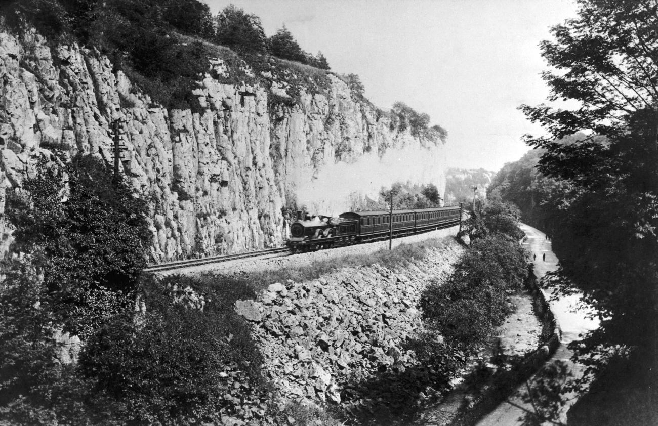 A steam train passes along the Buxton branch of the Midland Railway in Derbyshire, 1910.