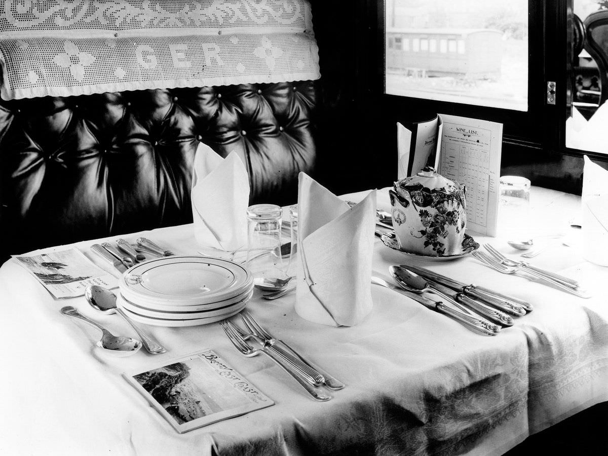 A first-class dining car on the Britain’s Great Eastern Railway—also known as GER, as shown on the embroidered seat cover, 1912.