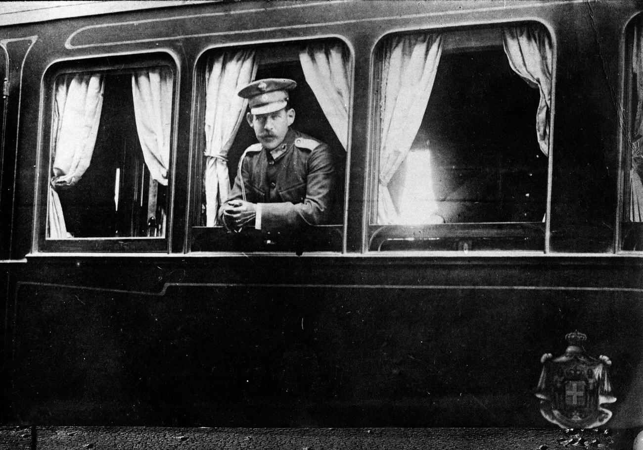 Constantine I ;eaving Athen by train, watching out of the lounge car, 1910