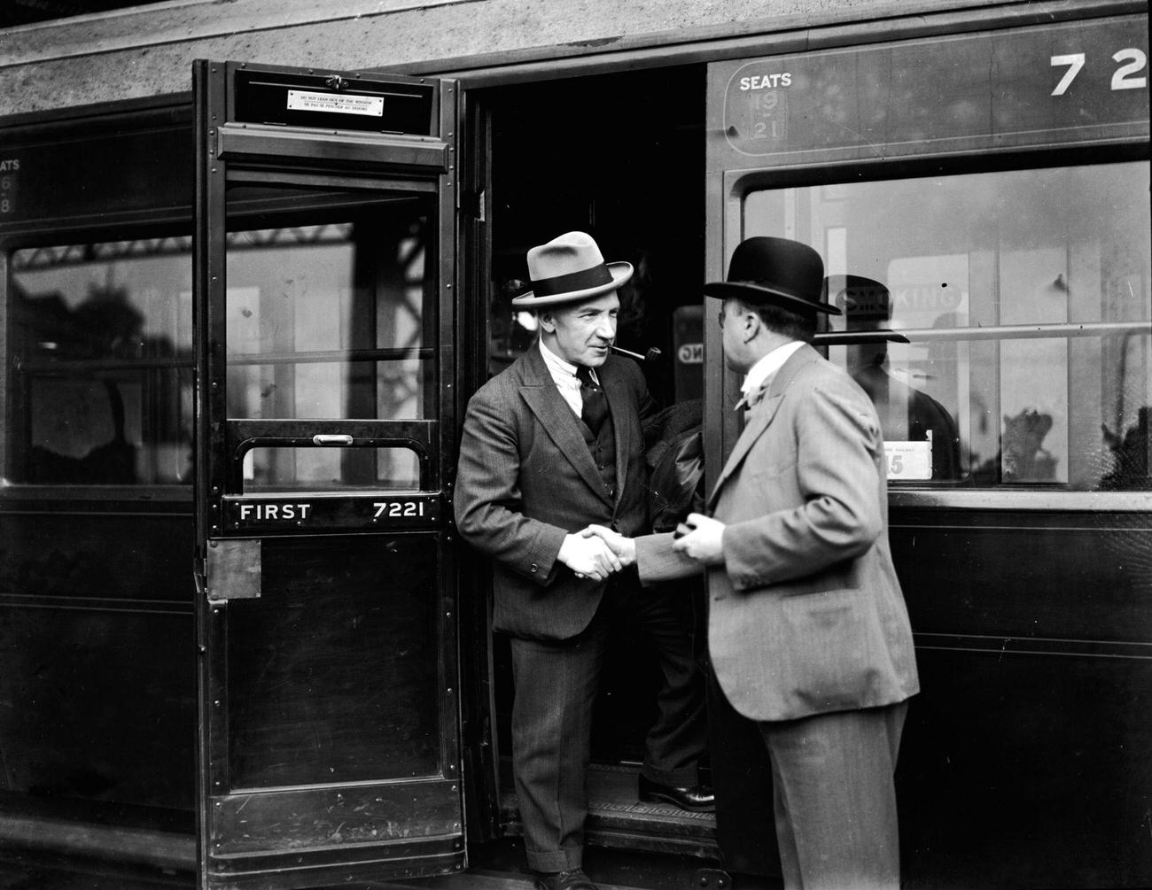 Douglas Hamilton greeting Sir Harry Lauder as he leaves a train at Waterloo Station, London, 1928