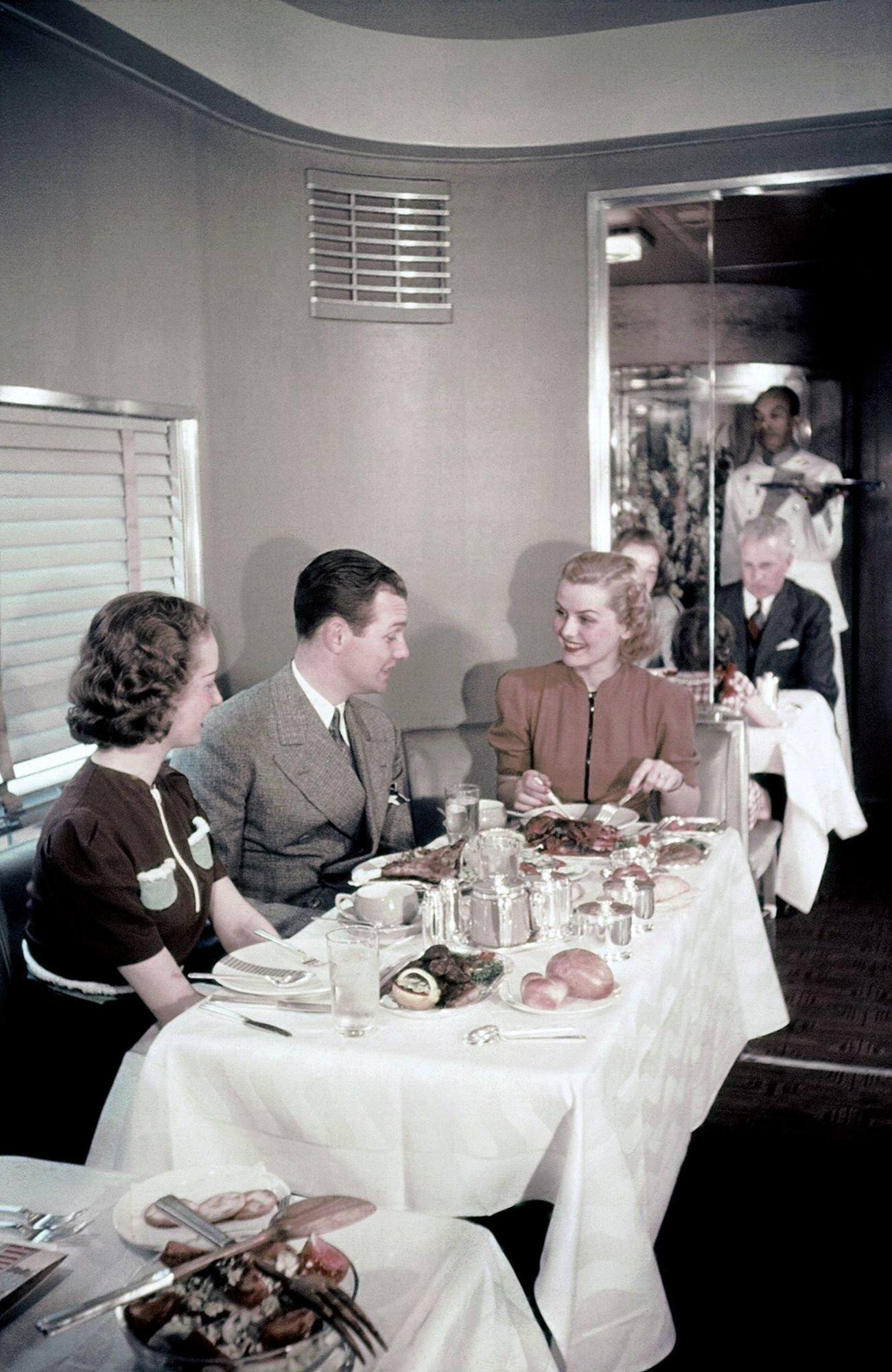Passengers sitting at a table in the observation car of New York Central System, 1938