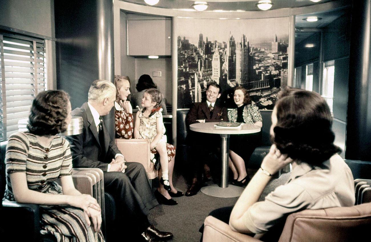 Passengers sit at a table in the Pullman dining car of New York Central System, 1938
