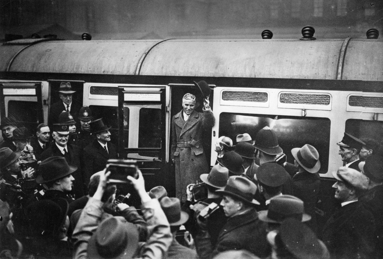 Charlie Chaplin arriving at Paddington Station in London, 1930s