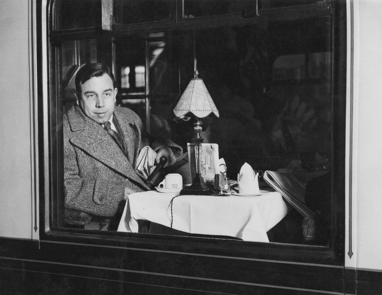 English playwright and novelist, J. B. Priestley at Waterloo railway station, London at the start of a trip to the USA, 11th February 1931.
