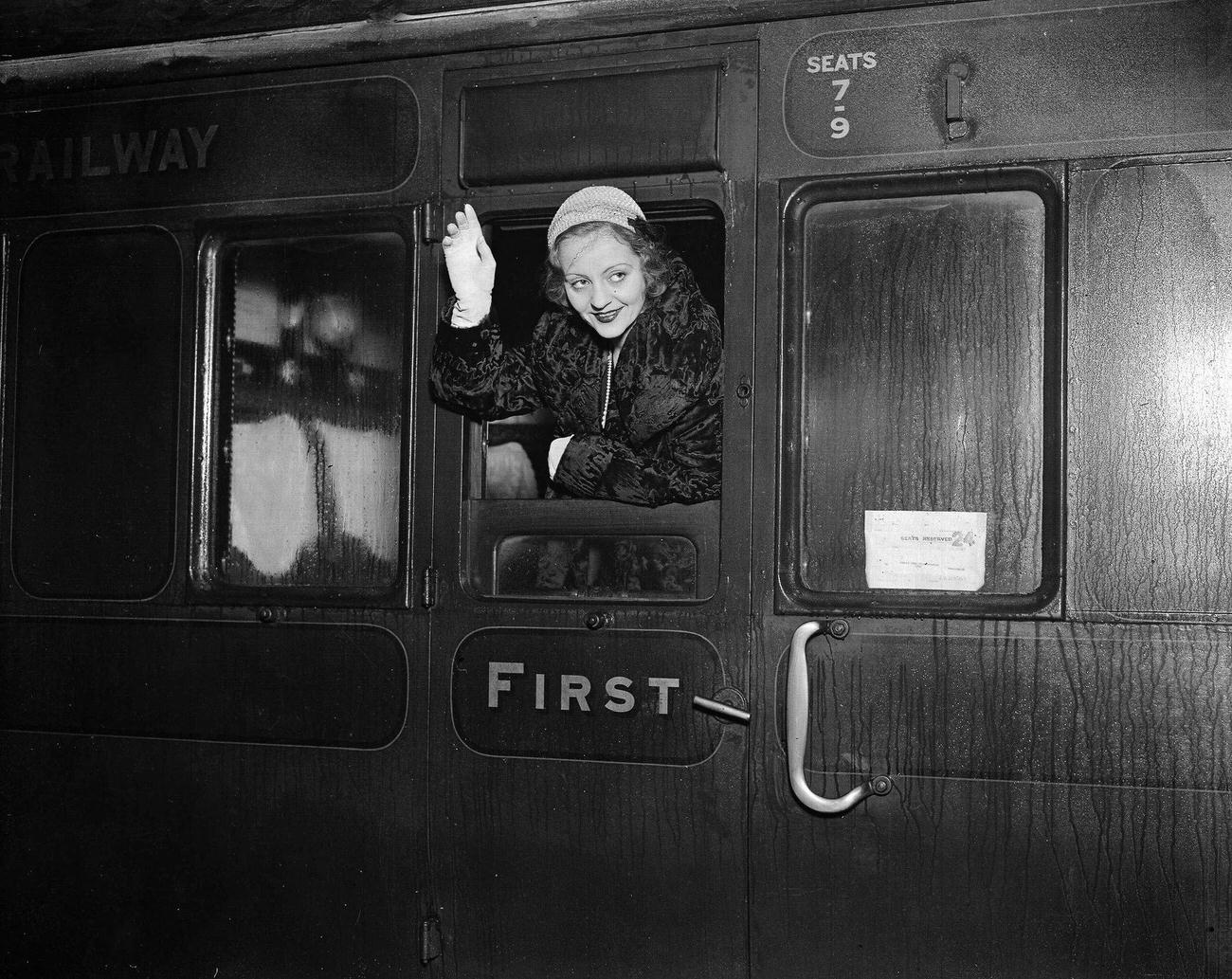 American actress Miss Tallulah Bankhead pictured waving as she leaves Waterloo Station on a train, en route for the USA, 1931