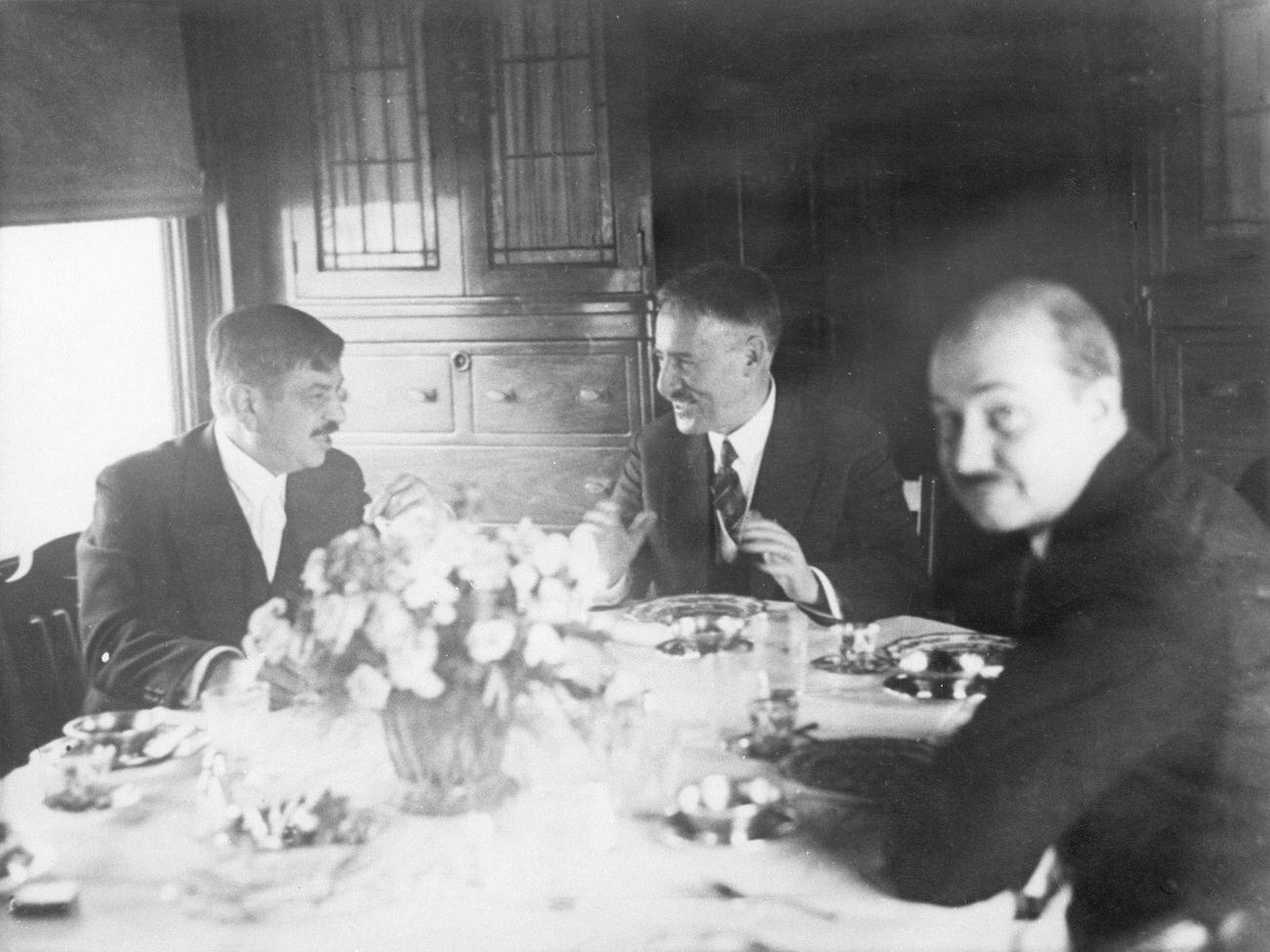 Pierre Laval on a visit to the USA, in the train from New York to Washington. From left: Pierre Laval, Henry Lewis Stimson and interpreter Marriner having lunch