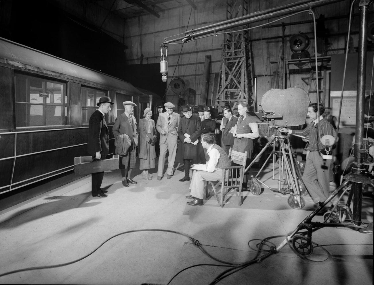 A film director giving instructions to his actors on a train