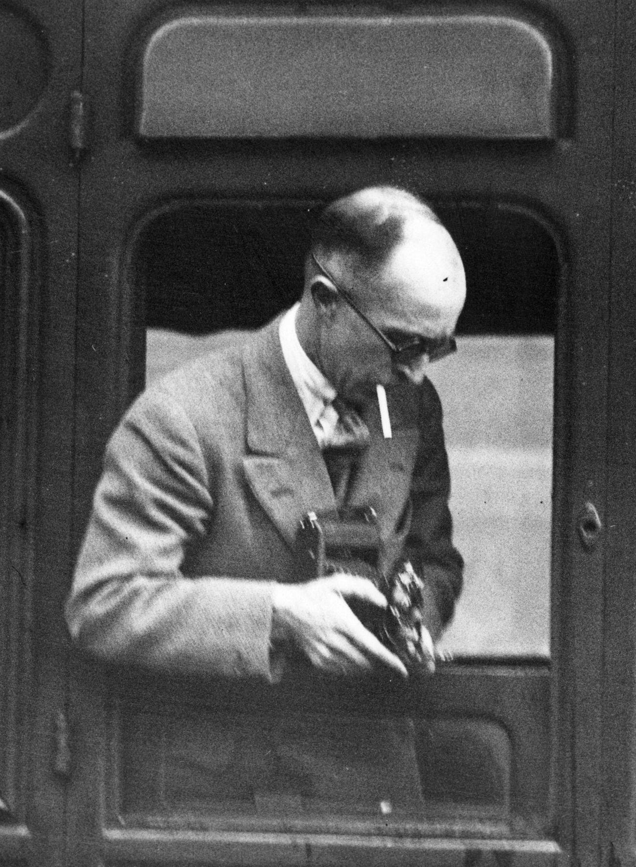 bAmerican photographer James Abbe traveling in the train, 1930s