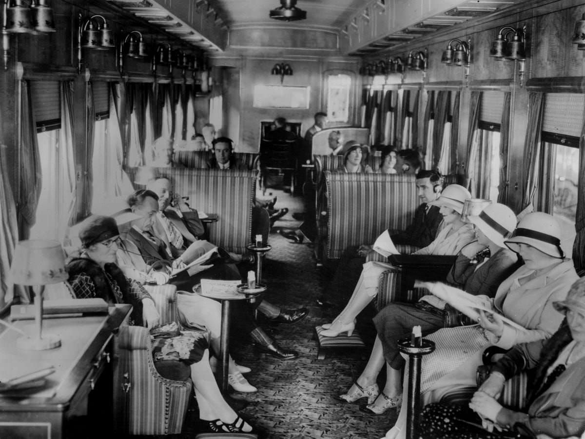 Passengers listen to the wireless on board a train on the Canadian Pacific Railway, September 1930.