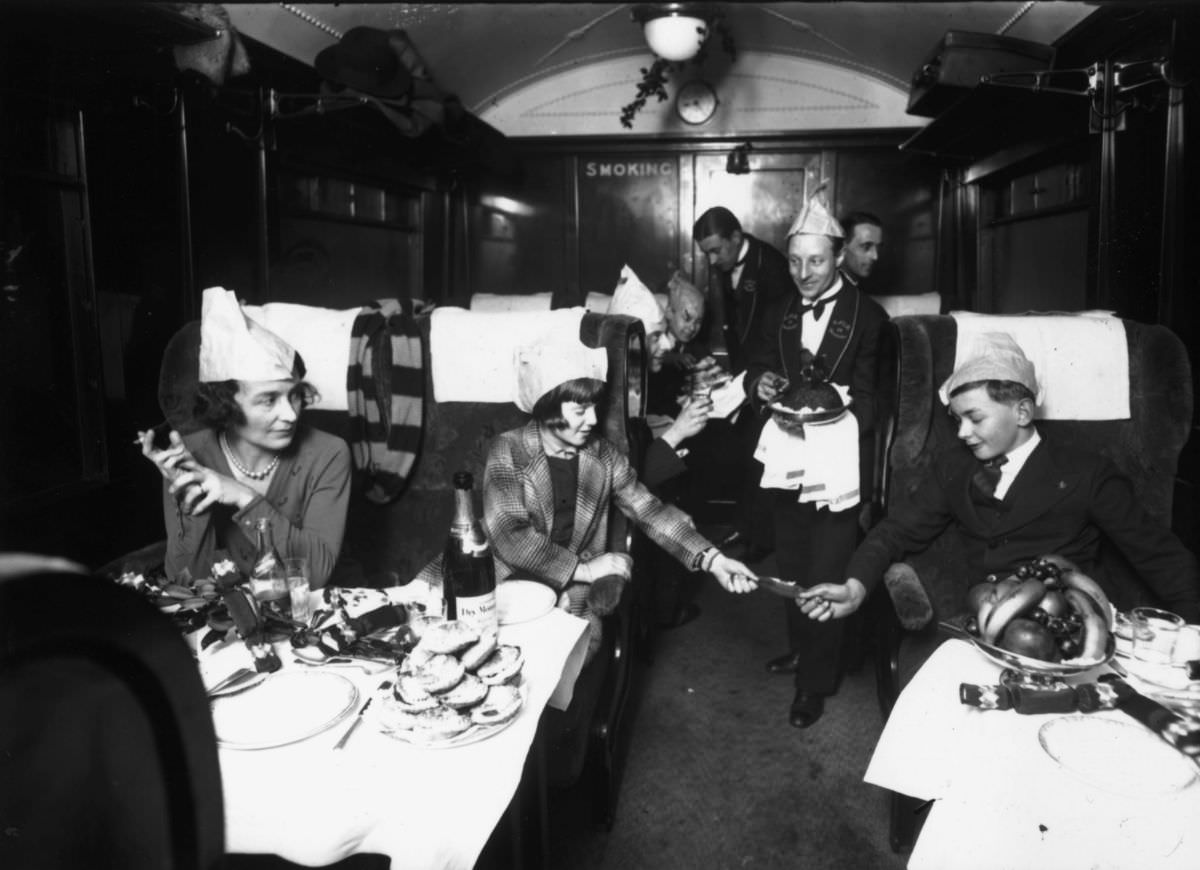 Family enjoying Christmas dinner in the Flying Scotsman restaurant car, 1931.