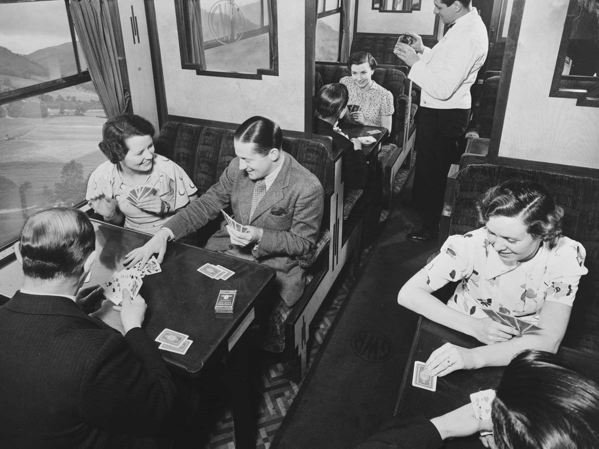 Passengers play cards in a Great Western Railway (GWR) dining car, 1938.