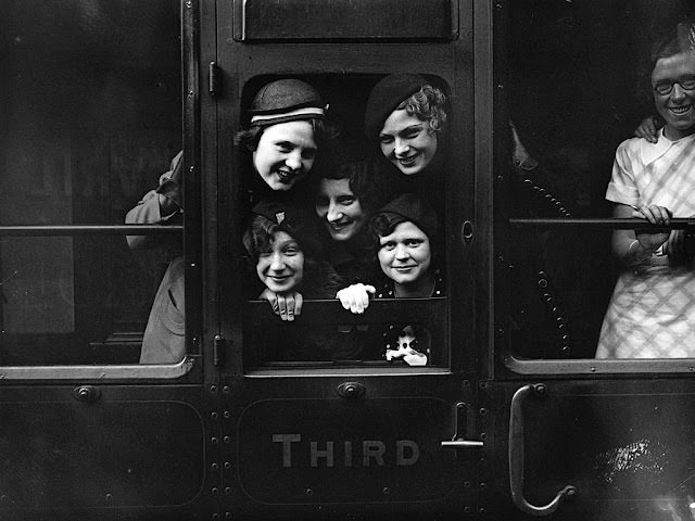 No sweats or hoodies here. Employees of Messrs Carreras peer out of their railway carriage window prior to departure from Charing Cross Station, London, in 1934.