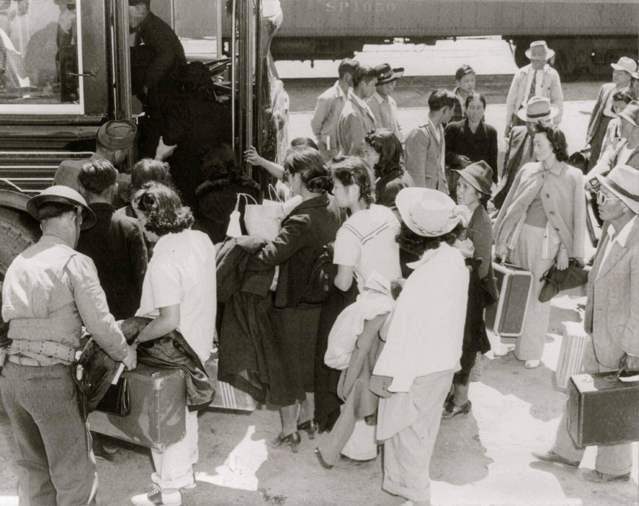 Lone Pine, Calif., May 1942 - a group arriving by train from Elk Grove, and boarding a bus for Manzanar, a War relocation authority center where evacuees of Japanese ancestry from certain West Coast, 1942