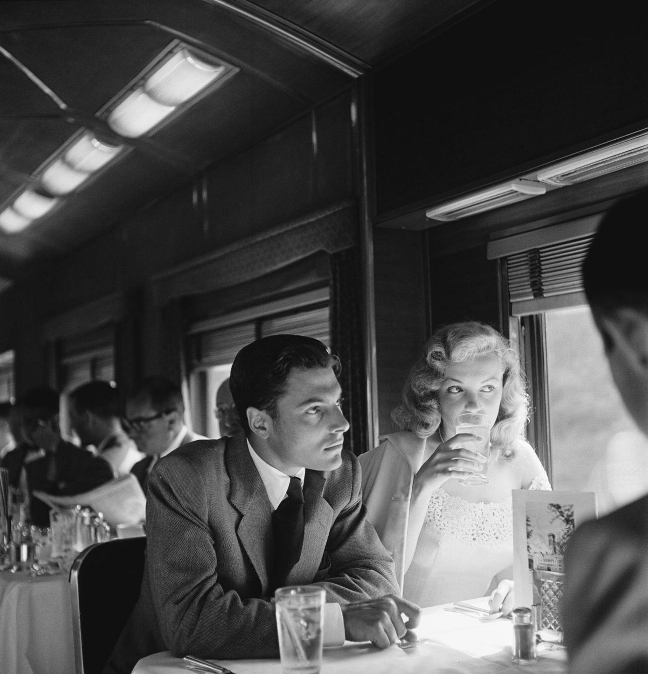 Marilyn Monroe and actor Lon McAllister on a train from New York City to Warrensburg, New York, June 1949.