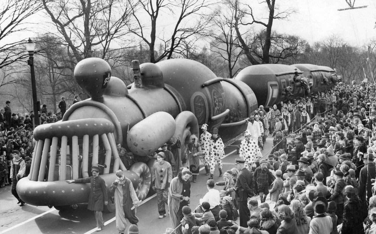 The train balloon is led along Beacon Street on the route of the annual Santason parade, 1941