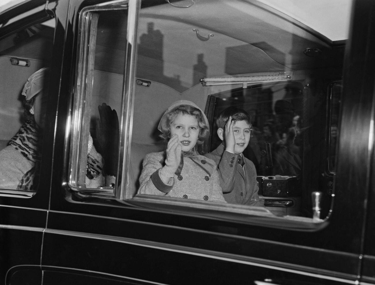 Princess Anne and her brother, Prince Charles (now King Charles III) arriving at Liverpool Street Station, London, 22nd December 1958.
