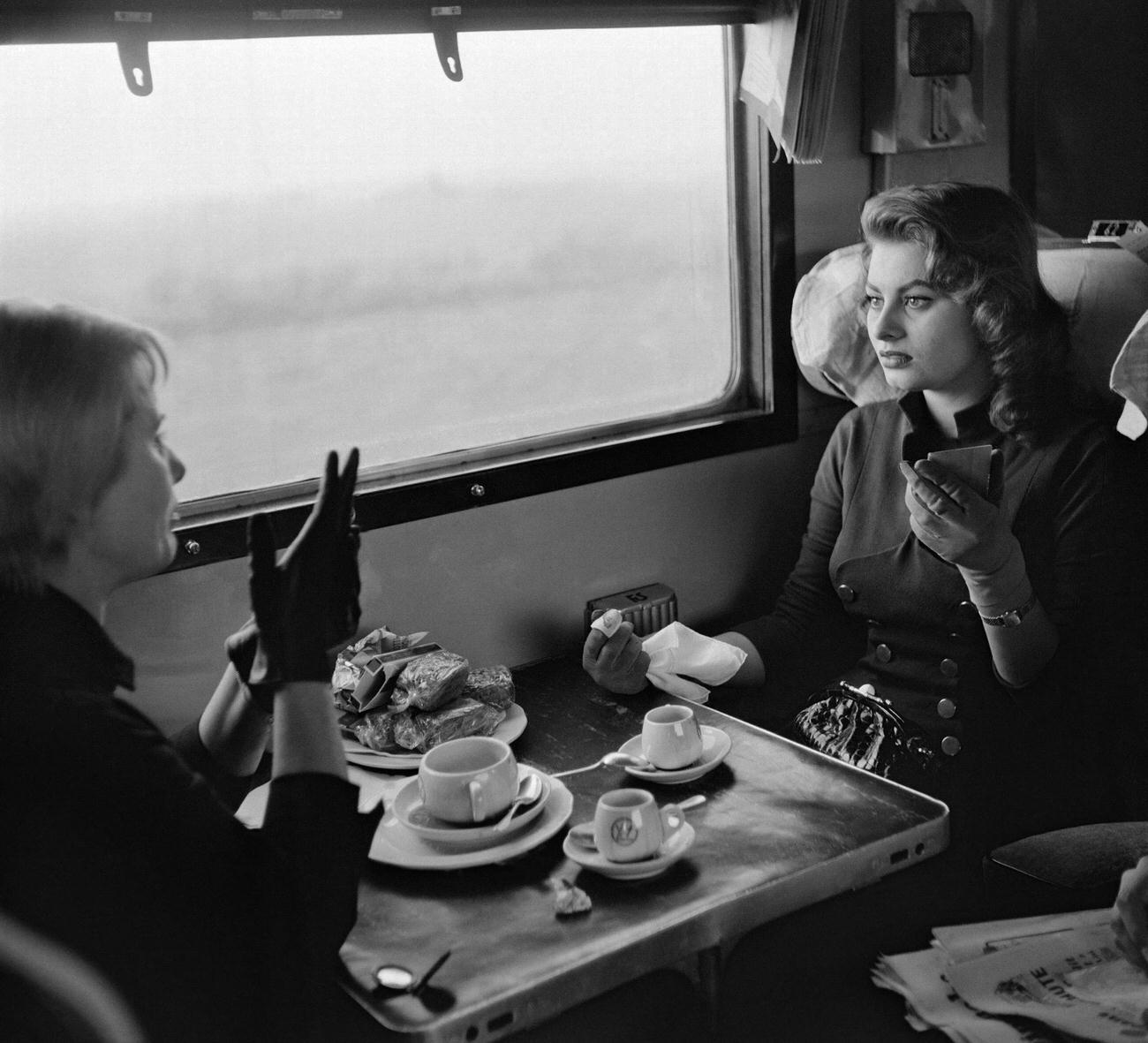 Actress Sophia Loren visits US Military Base in Italy, 1950. The actress having breakfast in the train, fifties.