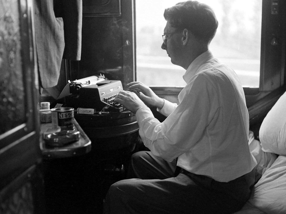 A man uses a typewriter while riding the Venice-Simplon Orient Express, 1950.