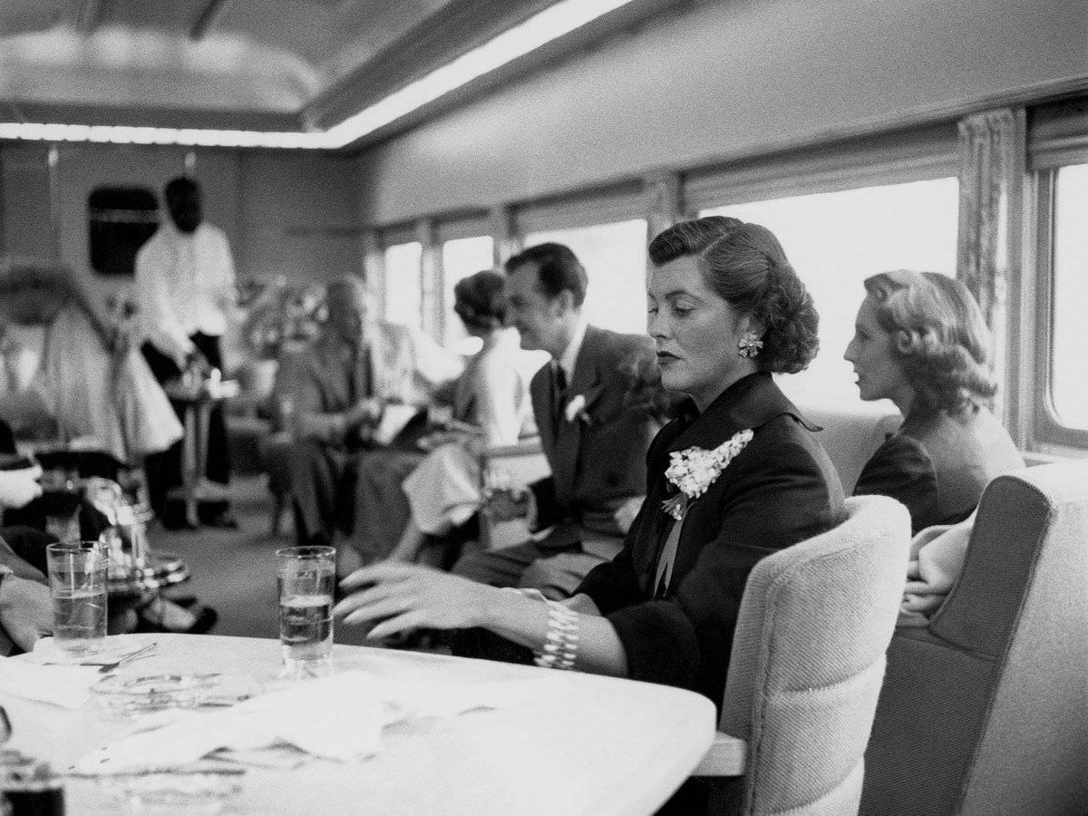 Veronica Balfe (wife of actor Gary Cooper) has a cocktail on the Super Chief railroad, 1951. The train was a favorite of celebrities traveling between Chicago and Los Angeles.