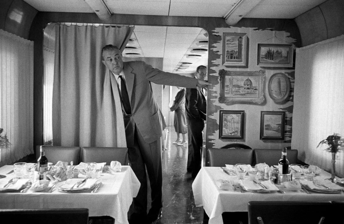 French actor, director and mime Jacques Taty examines the dining car train, September 1958.