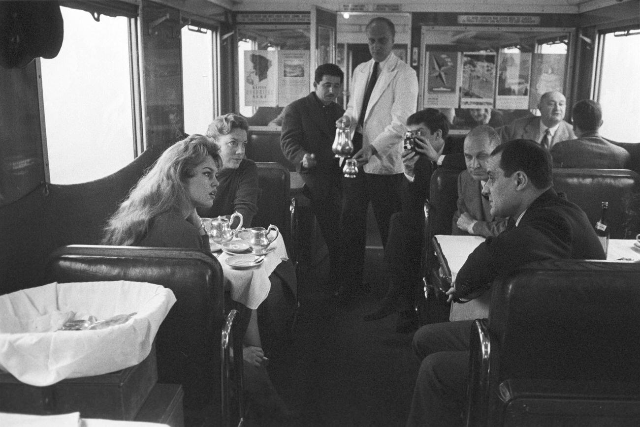 Brigitte Bardot in the restaurant compartment of a train, 1957