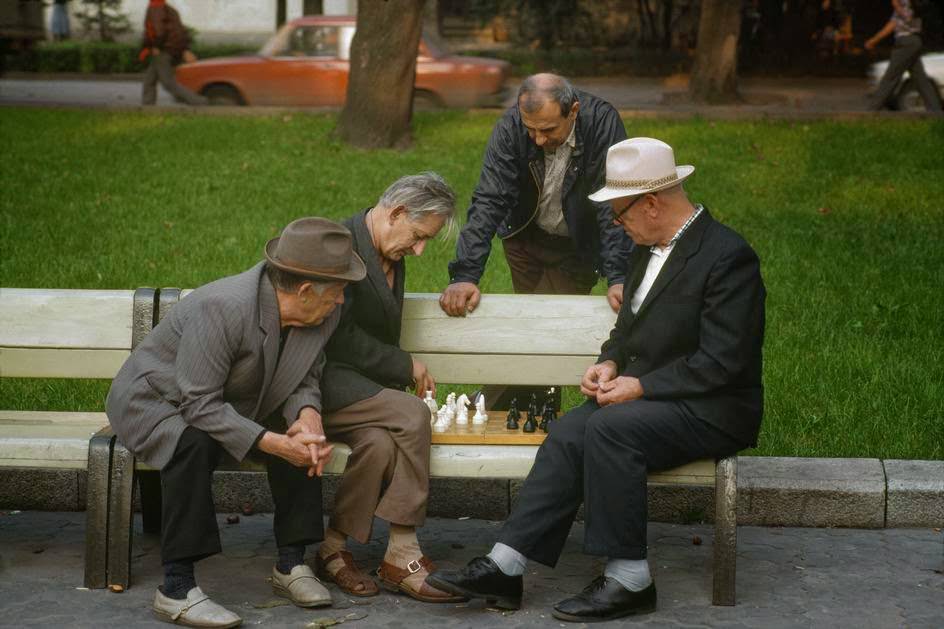 Chess players and casual spectators in the park. Lviv.