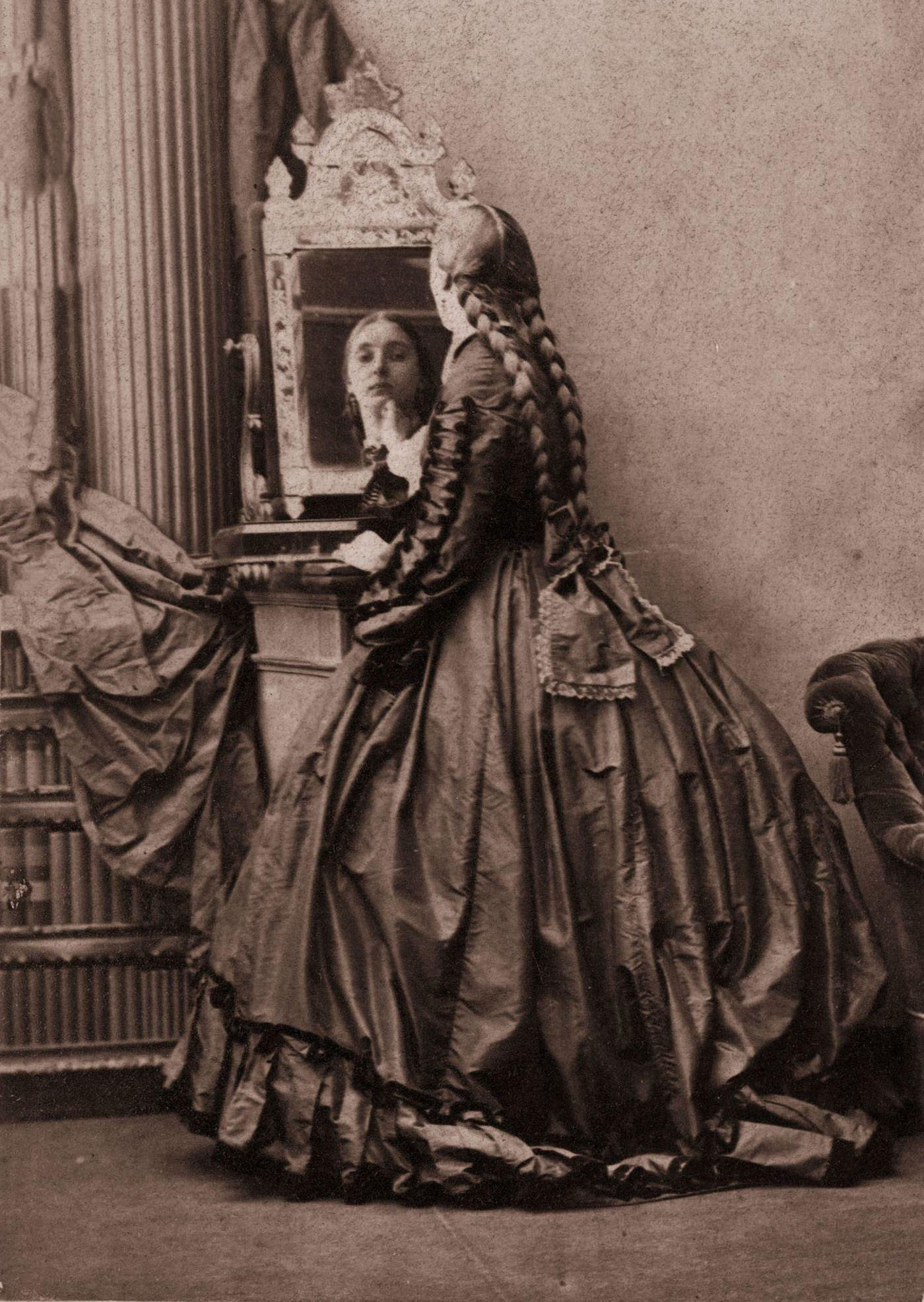 A Victorian woman in a crinoline with her hair in long plaits which reach to her waist, 1858