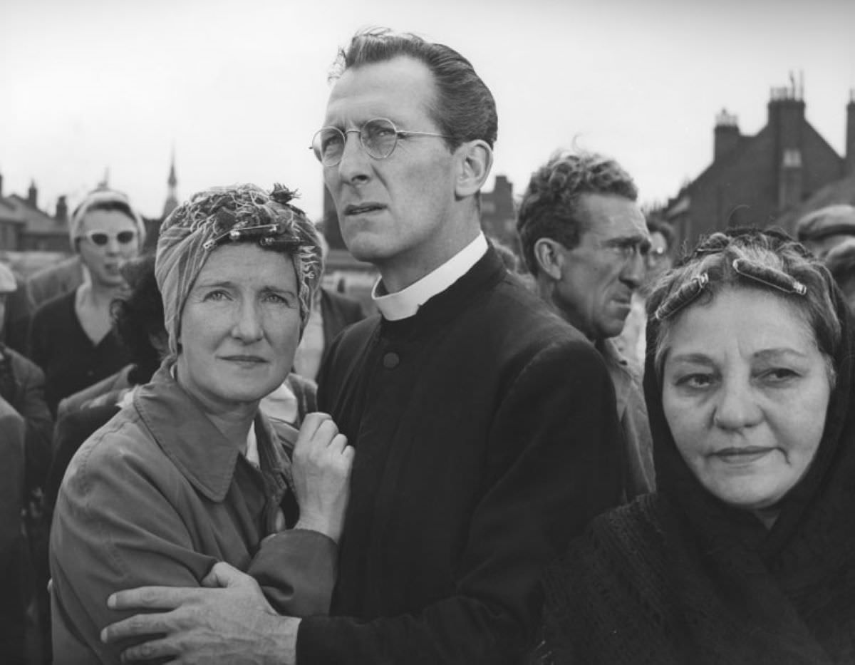 Peter Cushing as the Priest who tries to save Johnnie.
