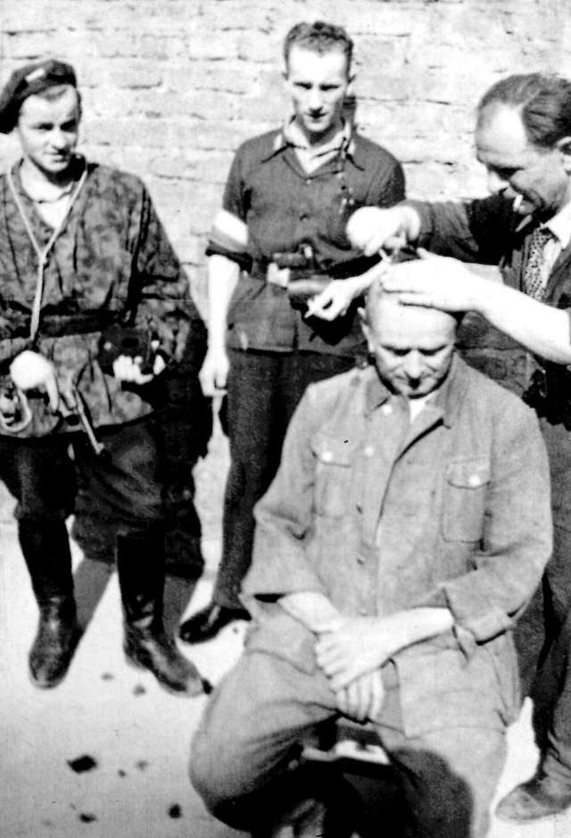 A German POW having his head shaved in the PKO building.