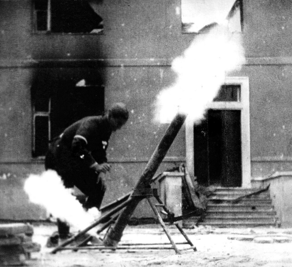 Man firing at German positions from Piusa XI Street using a grenade launcher.