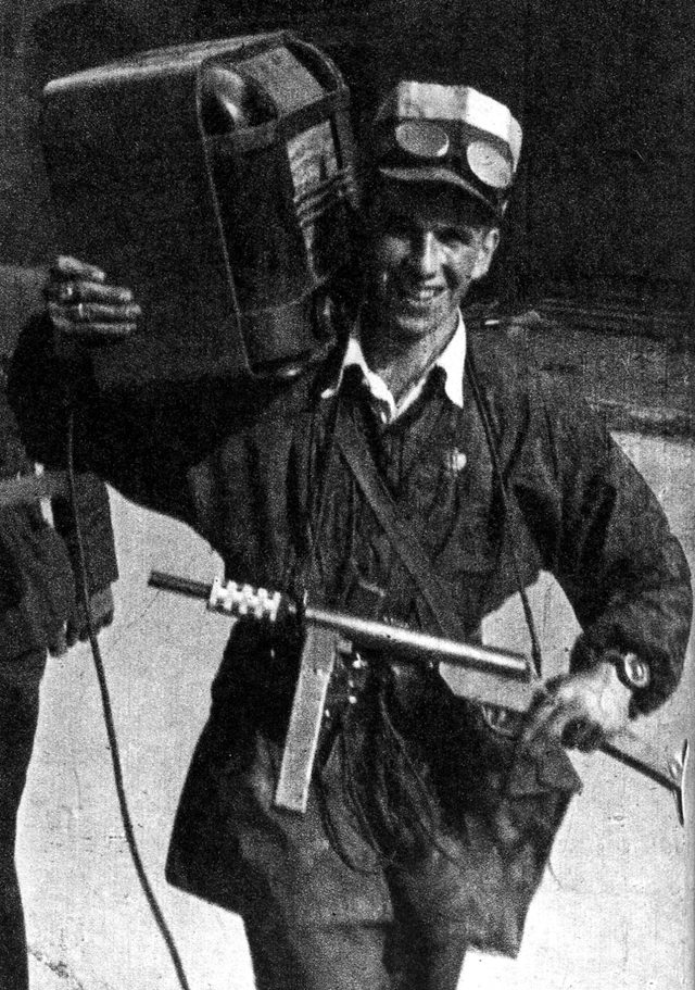 A Polish partisan carrying a Błyskawica submachine gun and a radio.
