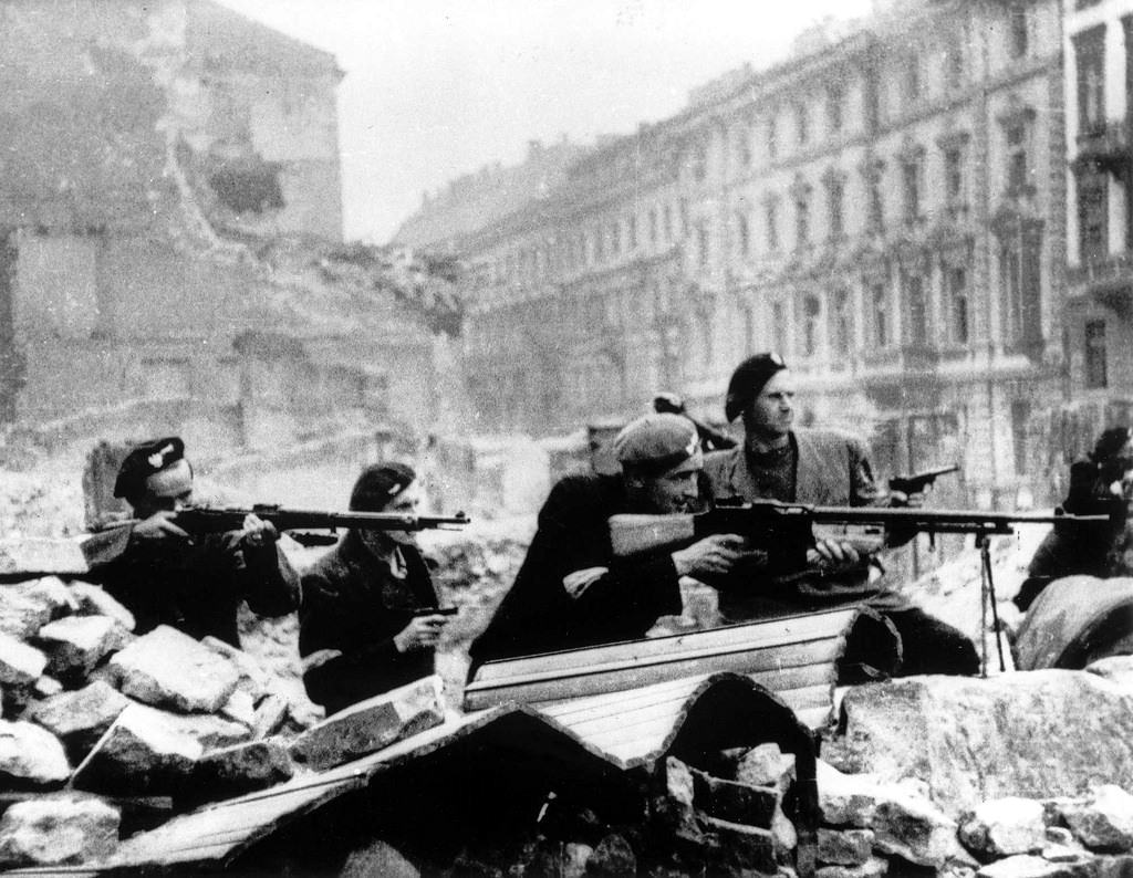 Polish partisans in position behind a barricade on Mazowiecka Street.