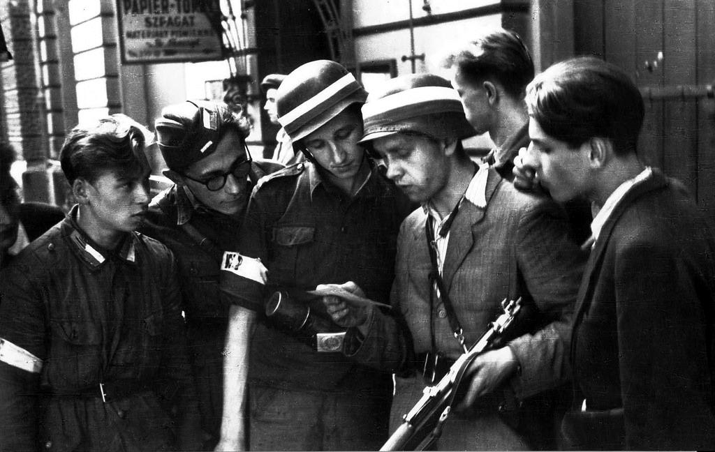 Polish partisans reading a German propaganda leaflet urging them to surrender.
