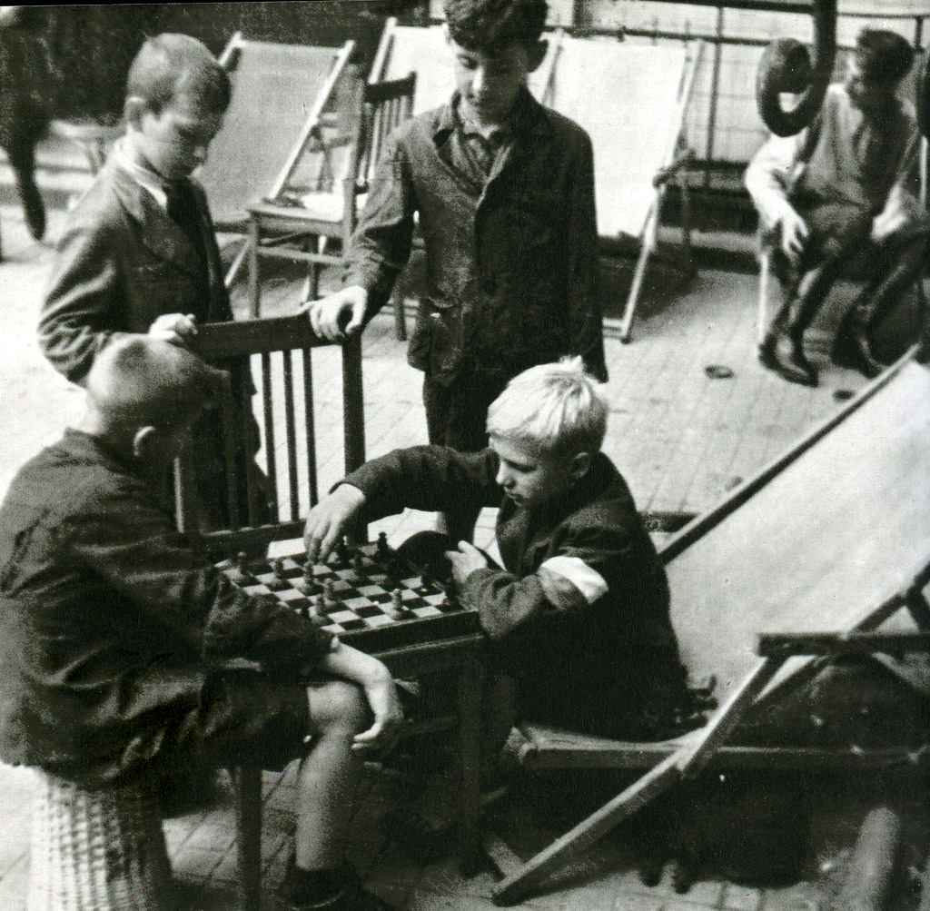 Young insurgents playing chess on streets.