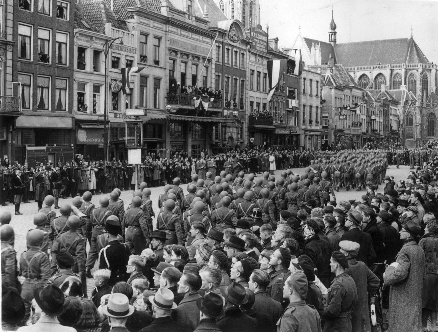 Soldiers of the 1st Polish Armoured Division form a triumphant procession through the streets of Breda in the Netherlands, after liberating the city from the Germans during World War II.