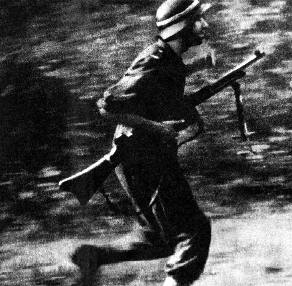 A Polish partisan of the Baszta battalion on the move.