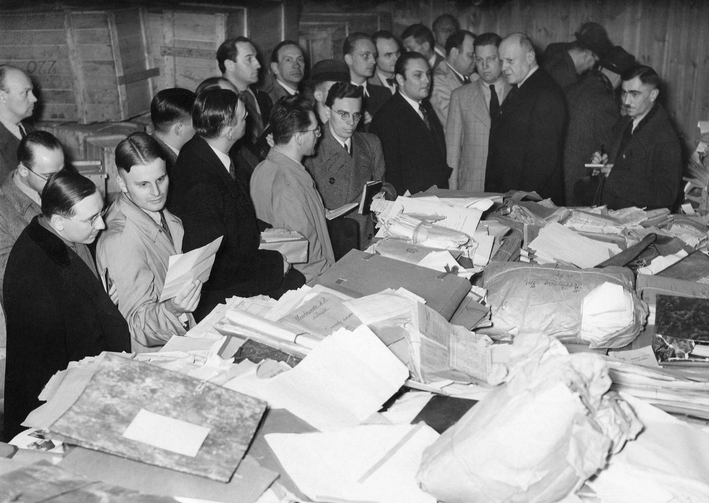 This photograph shows journalists examining documents belonging to the Polish secret service that were captured at the Polish Ministry of Foreign Affairs in Warsaw.