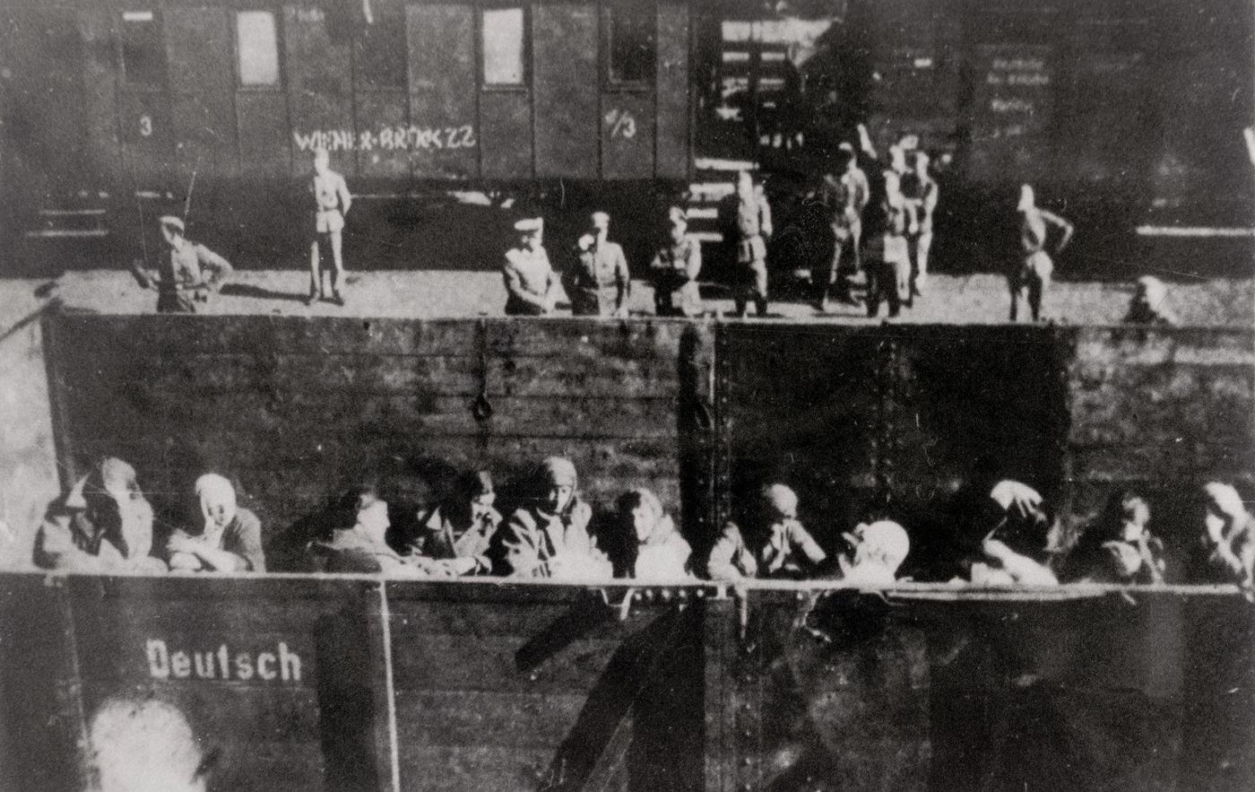 Deportation of Polish Jews in open cattle carriages at the "reloading point" in Warsaw, on the platform German soldiers in Poland, 1944