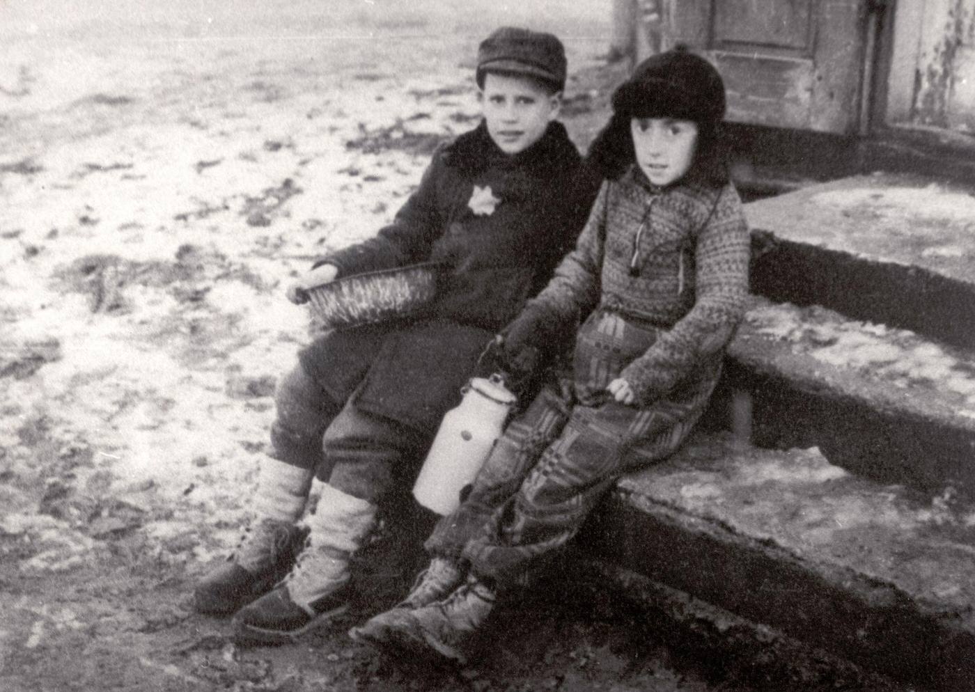 Two children in the snow covered Ghetto of Warsaw, 1944
