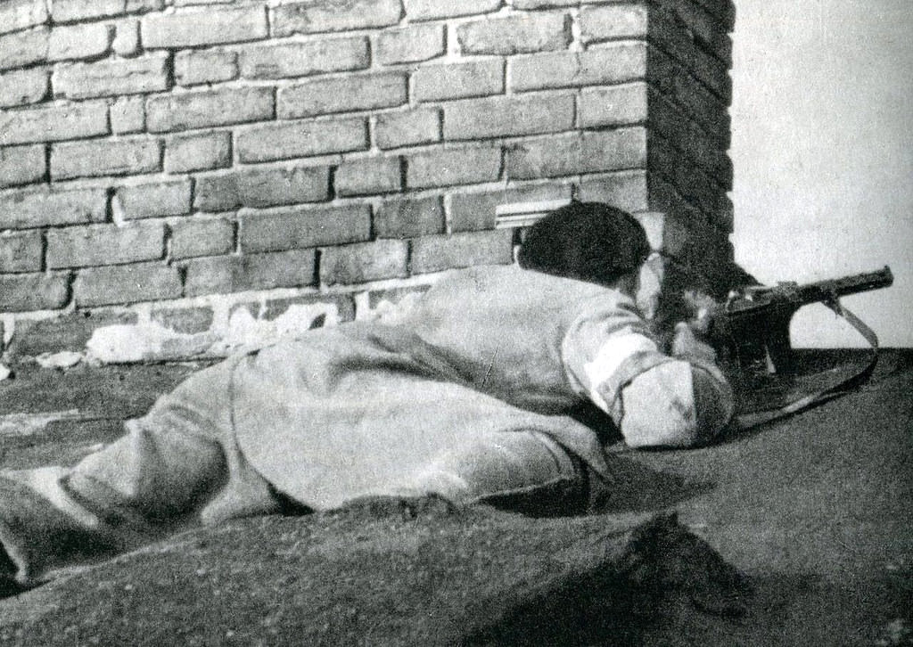 A Polish sniper on a rooftop overlooking the Ewangelicki cemetery in Warsaw, 2nd August 1944.