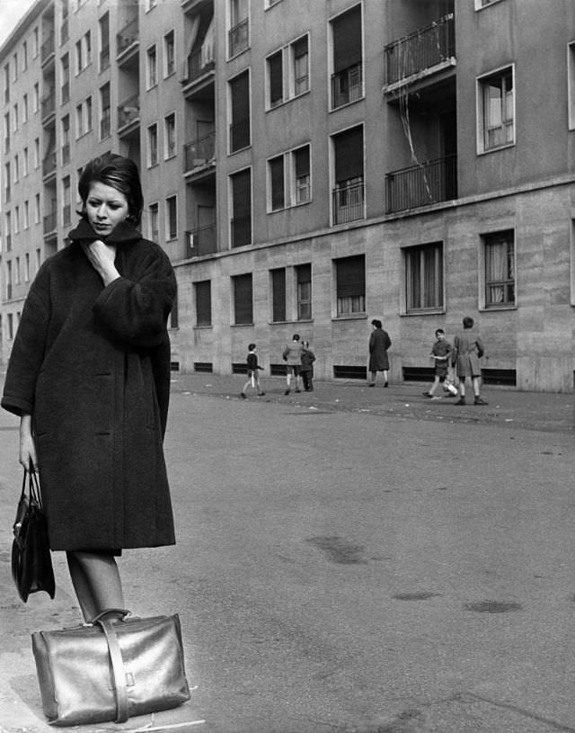 A young woman trying to protect herself from the cold during winter, 1961. (Walter Mori)