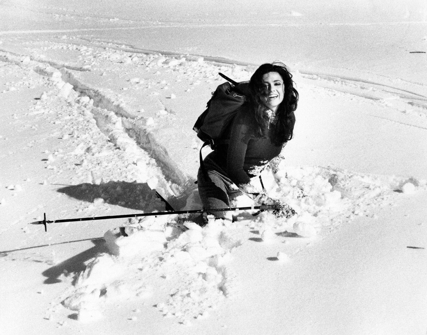 Italian singer Gigliola Cinquetti playing on the snow with a ski stick in her hand. San Giorgio, 1974.
