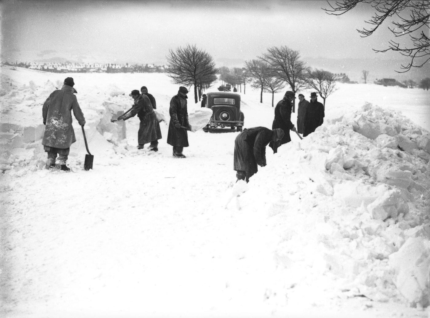 German/Italian prisoners of war clearing snow on Fairfield Common, Buxton, Derbyshire, 1947.