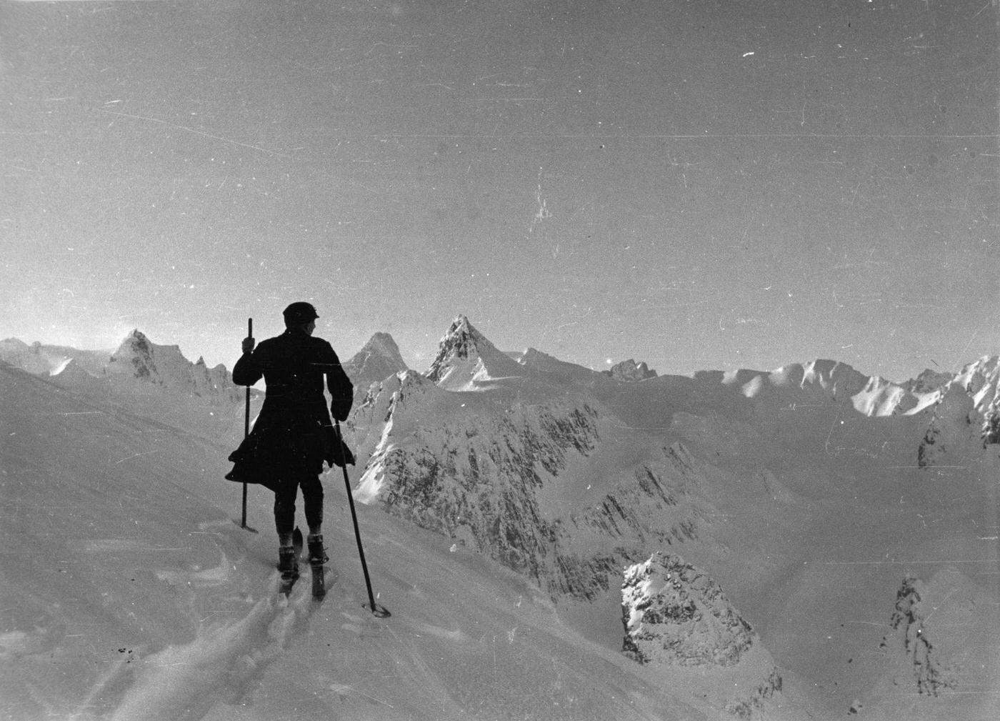 The prior of the hospice ascends the Mont Mort with skis. The Mont Mort is the frontier between Italy and Switzerland.