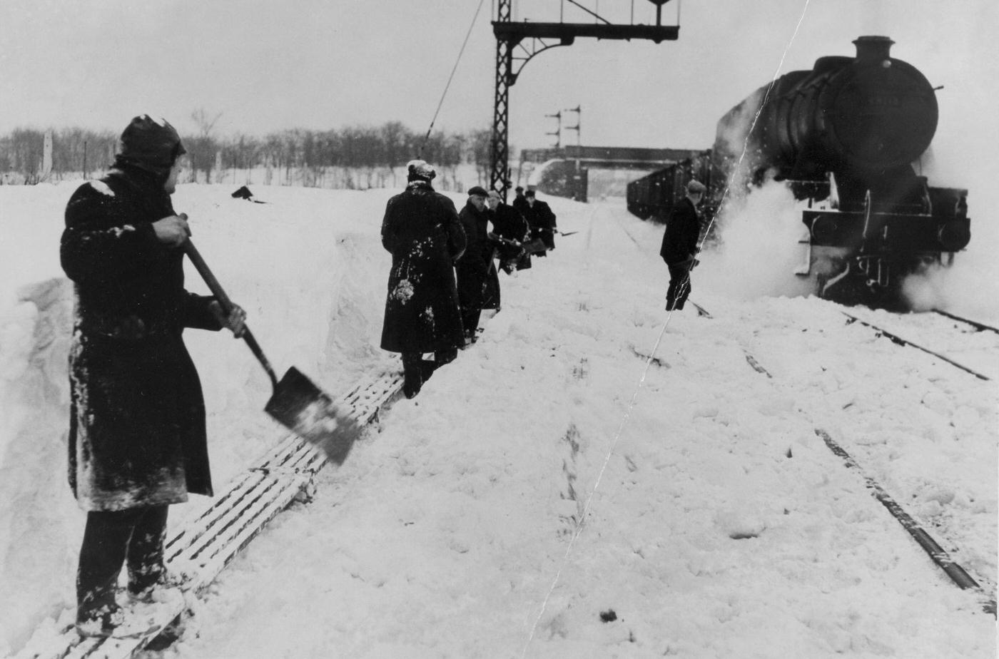 Men at work on the railway line near Kingsthorpe Mill, clearing snow from the lines