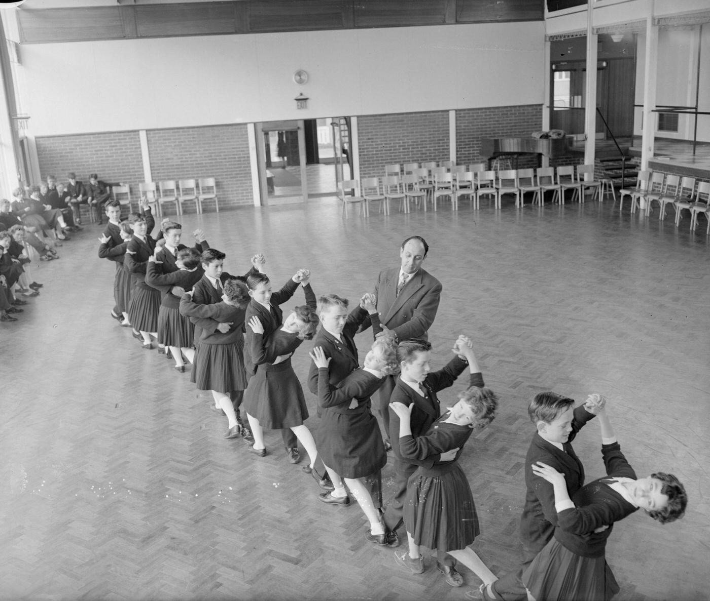 Dance teacher Sidney Winter instructing a line of young formation dancers at the Holmshill Secondary School in Boreham Wood, Hertfordshire.